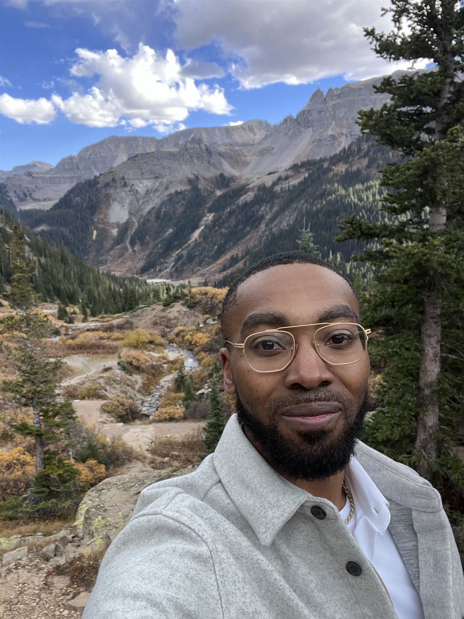 Nigel Benton standing before a mountain landscape